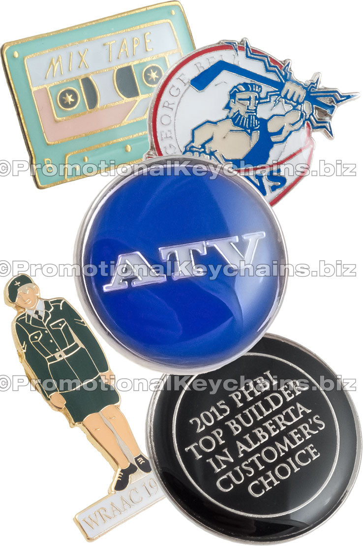 Group of Classic Raised Metal with Epoxy lapel pins showing different colors and shapes. Designs shown included a silver and blue pin with text ATV, another of a figure in uniform, and another in the design of a mixed tape.