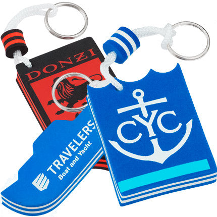 Three colorful foam floating keychains featuring logos for Donzi, Travelers Boat & Yacht, and CYC.