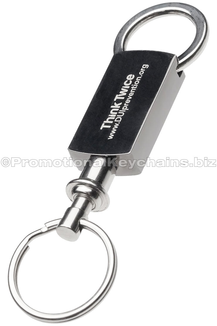 A polished metal keychain featuring a text engraving and a pull and twist attachment on the bottom.