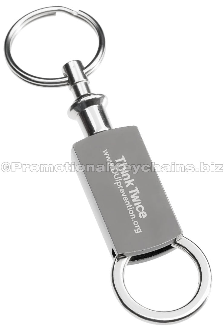 A polished metal keychain featuring a text engraving and a pull and twist attachment on the bottom.
