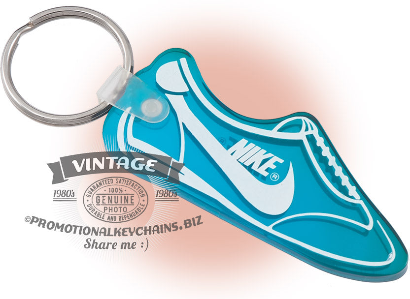 Vintage Nike shoe-shaped vinyl keychain in teal with white imprint, custom-made in the USA in the 1980s