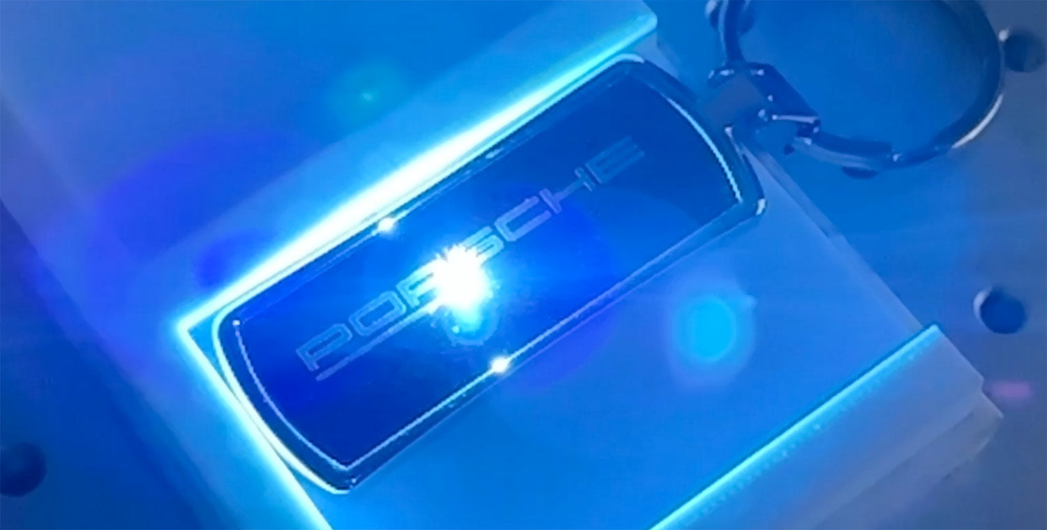 Front side engraving on a metal keychain with laser flare