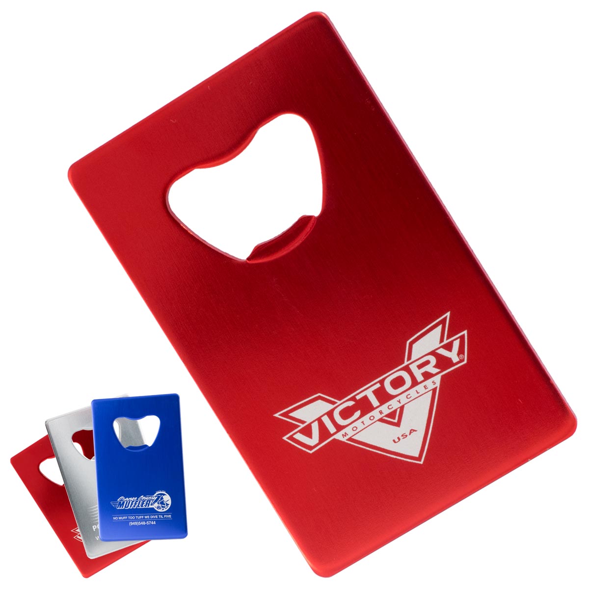 Red credit card sized promotional bottle opener with a custom engraved logo. The image also shows the opener in red, silver, and blue color options in the lower left corner.
