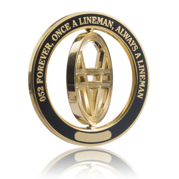 Gold and black coin with spinning center element containing text on a white background