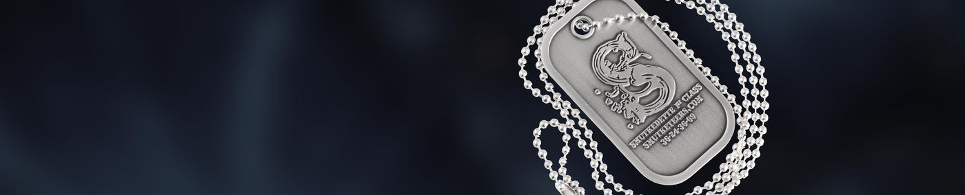 Custom made silver dog tag and chain with logo and text on a dark background