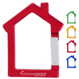 Red house shaped carabiner with a custom engraving on the bottom. Smaller house carabiners are shown on the right side, they are green, gold, red, and blue.