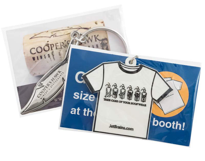 Keychain with t-shirt design and branding information on a white background