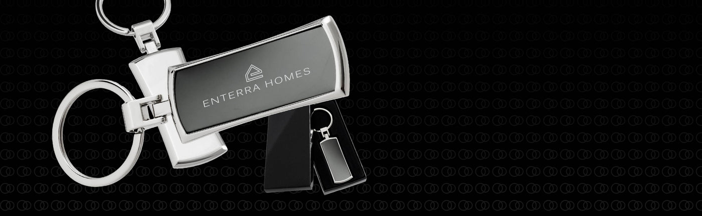 Metal keychain with custom engraved branding, showing front back, and gift box on dark background. 