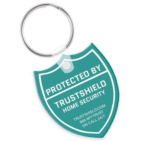 Teal keychain shaped like a shield with a white custom imprint