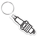 White keychain shaped like a spark plug with a black imprint depicting the spark plug