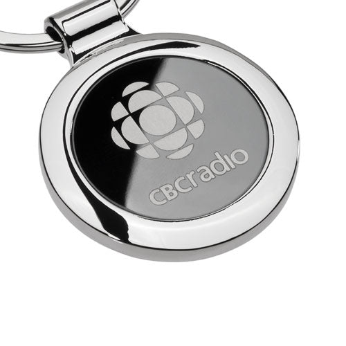 Silver keychain with engraved logo on a white background