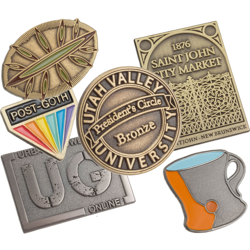 Layered image of antiqued lapel pins showing different colors and shapes.  Platings shown antiqued gold, brass and nickel. Some designs have enamel colors, blues, greens and oranges. 