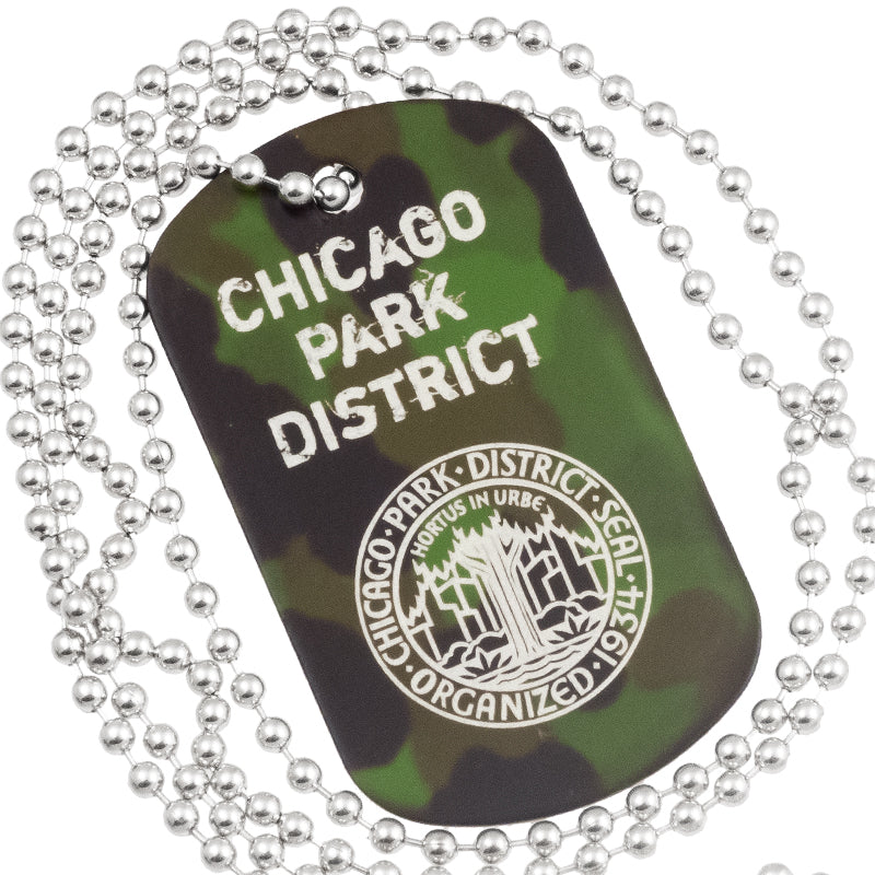 Close up example of camouflage anodized aluminum dog tag with engraving of text and logo. Image also shows the 30" ball chain. 