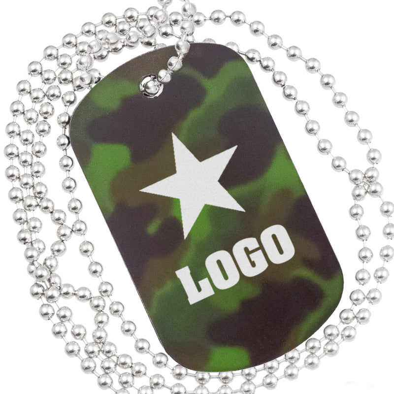 Close up example of camouflage anodized aluminum dog tag. The engraving is of bold text and graphic of a star.  