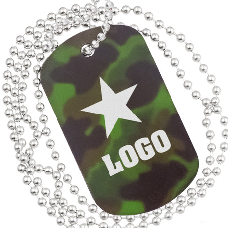 Close up example of camouflage anodized aluminum dog tag. The engraving is of bold text and graphic of a star.  