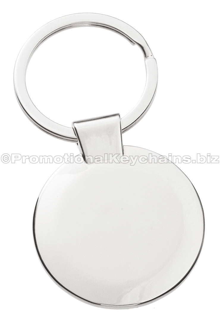 The blank back of a circular polished metal keychain.