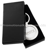 A polished circular metal keychain featuring an engraving and displayed in a black gift box.