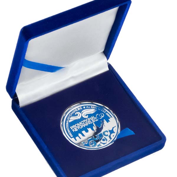 Silver coin with blue design in an open blue box on a white background