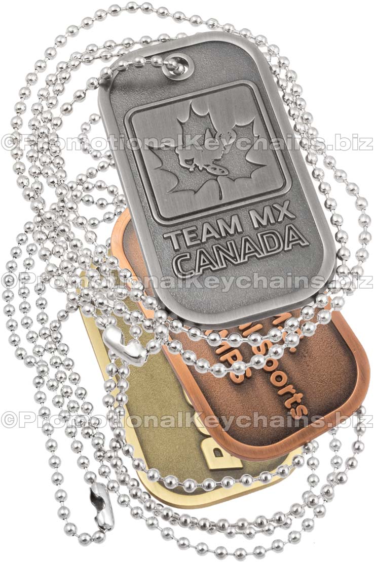 Group of Brushed Antiqued Die Cast Dog Tags. Tags are layered on top of each other and show examples of antiqued nickel, brass and copper plating. A 30" ball chain is looped around the tags. 