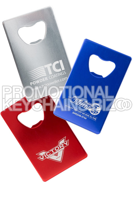Examples of silver, royal blue and red Credit Card Bottle Openers in Aluminum. Each has a silvery white engraving showing custom branding. 