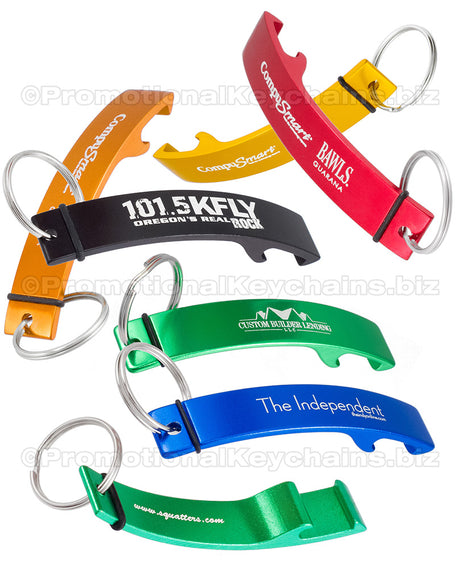 Image shows multiple Designer Logo Bottle Openers in different colors and with custom engravings. Colors shown are gold, red, orange, black, green and royal blue. There is also an example of the bottom side engraving with the green bottle opener. 