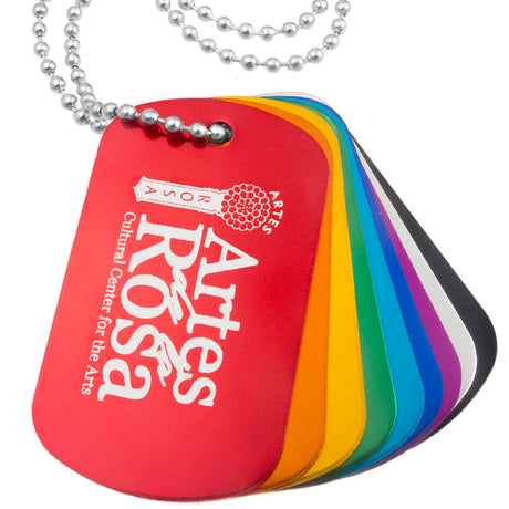 Close up image of engraved aluminum dog tags. Dog tags stacked on top of each other. 
Multiple colored tags shown - red, orange, gold, green, aqua, royal blue, purple, silver and black.