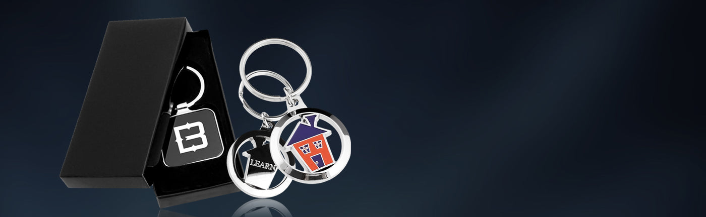 Keychains customized with logos and packaging on a dark background.