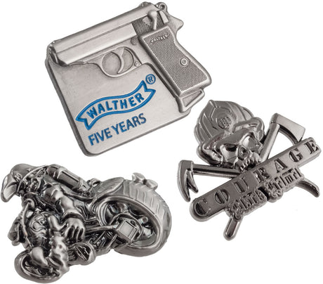 Image of three 3D custom shaped lapel pins. One of a gun, one of a figure on a motorcycle and one of a skull in a fire helmet.