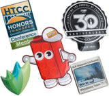 Layered image of Full Color Graphic Die Cut lapel pins showing different designs and shapes. Design include Lego brick with eyes and arms, 30th anniversary design and a leaf design. 