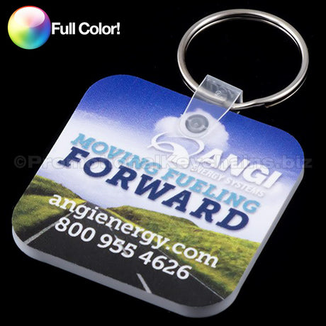 Rounded square vinyl keychain with full color custom branding against a black background.