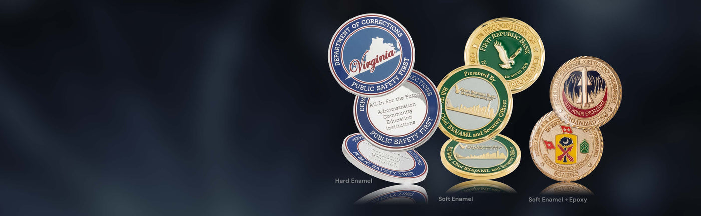 Collection of various coins showing difference between hard and soft enamel, on a dark background.