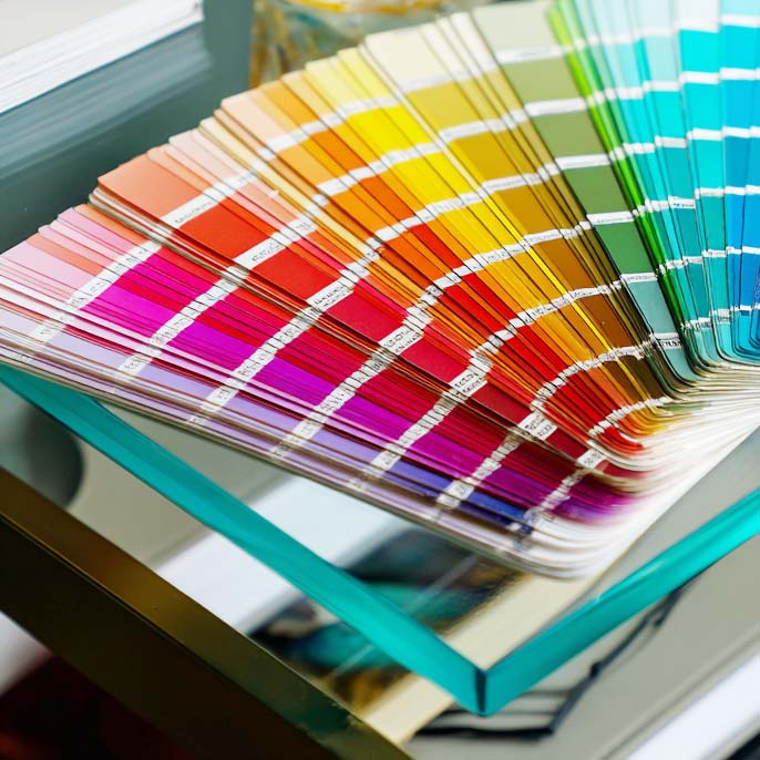 Color swatch book with a variety of colors on a table