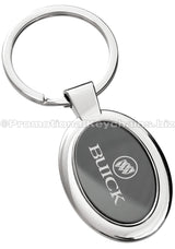 A polished metal ovular keychain featuring a black metal inlay engraved with the Buick logo.