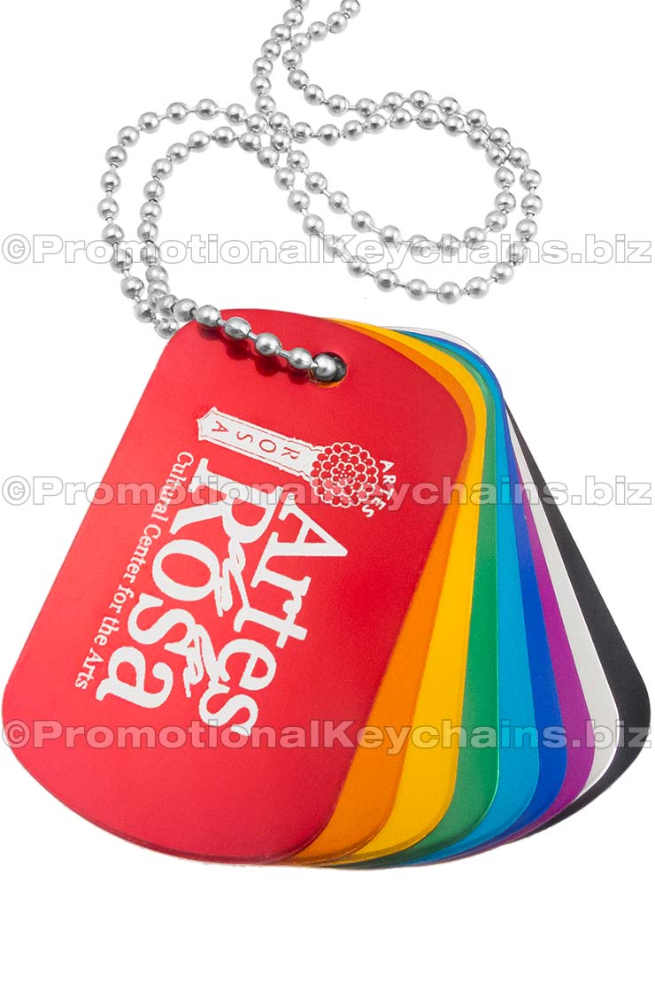 Image of engraved aluminum dog tags. Dog tags stacked on top of each other. 
Multiple colored tags shown - red, orange, gold, green, aqua, royal blue, purple, silver and black.