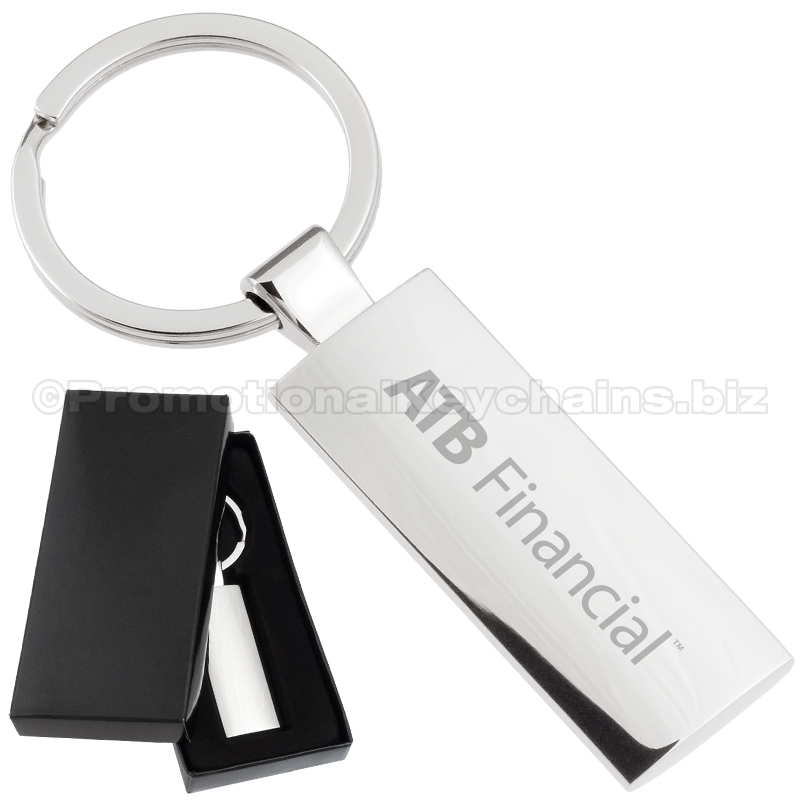 Product photo of a silver custom engraved keychain next to a black gift box